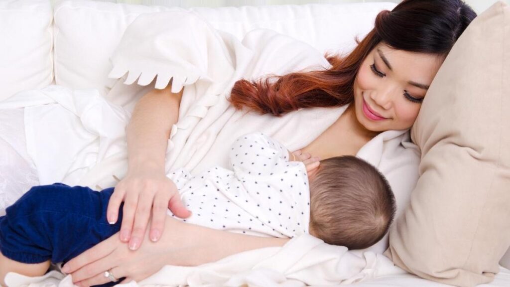 Baby feeding on the mother's breast after a breastfeeding massage