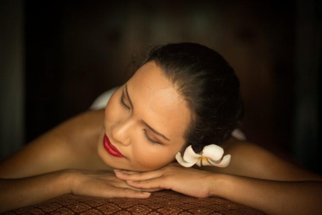 Young Asian woman lying on her stomach